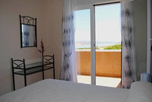 a bedroom with a bed and a view of a balcony at Alojamiento Rural Arucema in Freila