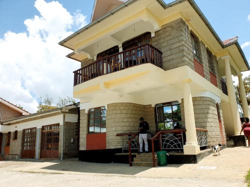 a man standing in front of a building at Merinja Guest House in Naivasha
