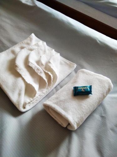 two towels sitting on top of a bed at Noclegi Wałbrzych - Pokoje Konrad in Wałbrzych