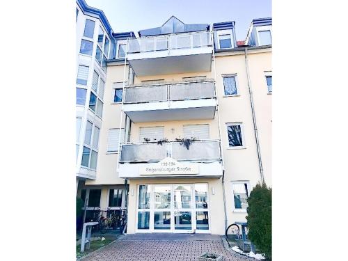a large white building with a store front at SUNNYHOME Monteurwohnungen und Apartments in Weiden in Weiden