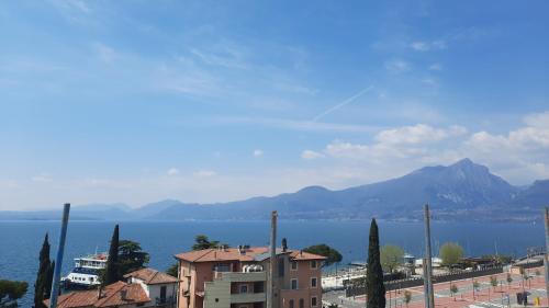 a view of a city and the water and mountains at Hotel Ristorante Al Caminetto WorldHotels Crafted Adults Only in Torri del Benaco