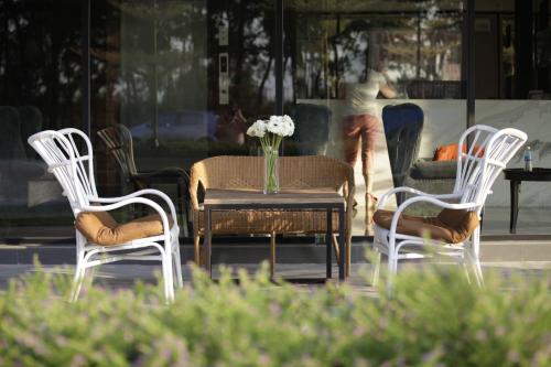 a group of chairs and a table with a vase of flowers at I am Jazz Hotel in Johor Bahru