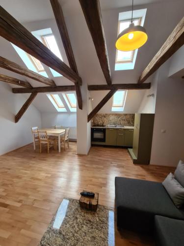 a living room with skylights and a table and a couch at dasHaus in Cisnădie