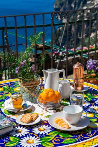 a table with plates of food on a colorful table cloth at YourHome - Casa Ivi Positano in Positano