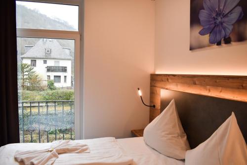 Ένα ή περισσότερα κρεβάτια σε δωμάτιο στο Winzerhaus Gärtner - An der Loreley