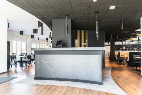 a large kitchen with a large counter top at Abasto Hotel München Feldmoching in Munich