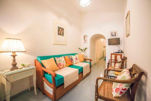 a living room with a couch and two chairs at Atrani Apartments on the Amalfi Coast, air-purified, close to the beach and easy access in Atrani