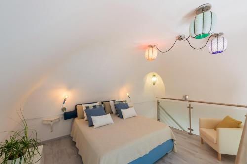 a small bedroom with a bed and a chair at YourHome - Casa Ivi Positano in Positano