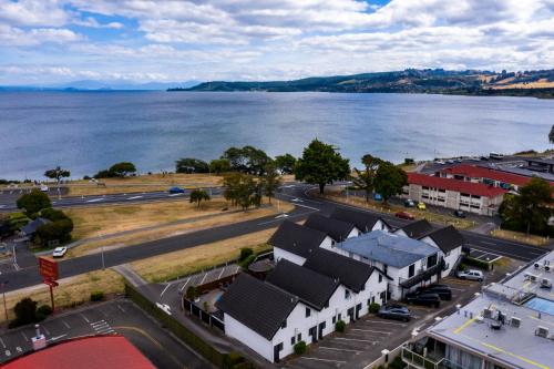 an aerial view of a town next to a body of water at Le Chalet Suisse Motel Taupo in Taupo