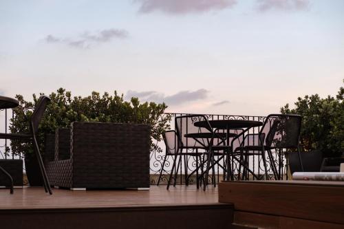 a group of chairs and tables on a balcony at 1926 Le Parisot Boutique Suites in Valletta