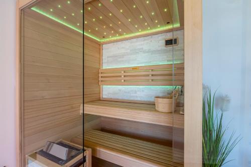 a sauna with wood paneling and a ceiling with lights at Villa SEVEN HEARTS with heated pool and private basketball playground near Split in Kaštela