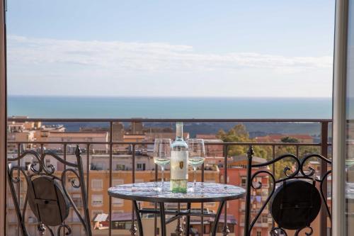 a table on a balcony with a view of a city at Esseneto Rooms in Agrigento
