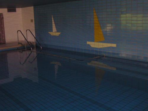 a swimming pool with a reflection of boats on the wall at Ferienwohnung Oshowski in Berchtesgaden