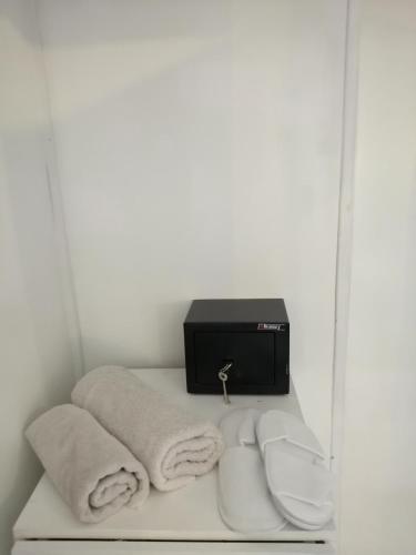 a shelf with towels and a tv on a wall at Santo Spiti sou 6 in Fira