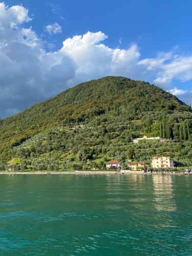 a hill on the shore of a body of water at La Foresta Monteisola in Monte Isola