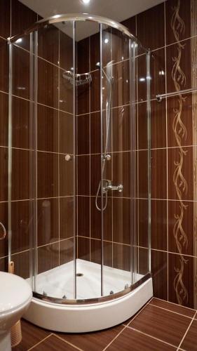 a shower with a glass door in a bathroom at Вила Марна - Villa Marna in Bŭlgarevo