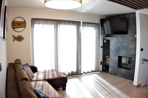 a living room with a couch and a fireplace at Horská Chata Ostružiny in Donovaly