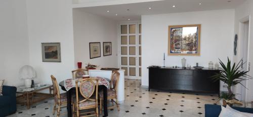 a living room with a table and a dining room at Casa Tigullio in Rapallo