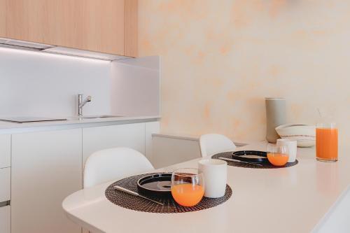 a dining room table with two plates and glasses of orange juice at 1881 LUXURY SUITES in Verona