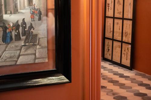 a painting on a wall with a checkered floor at Q92 Noto in Noto