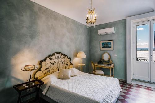 敘拉古的住宿－Dimora di Ulisse Sea View Holiday Apartment，一间卧室设有一张床和一个大窗户