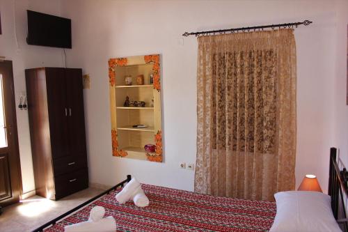 a bedroom with a bed and a mirror and a curtain at Traditional Stone house in Rhodes Town