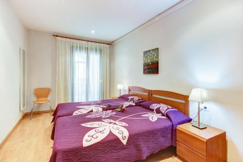 1 dormitorio con 1 cama de color púrpura y 1 silla en Migjorn 2 2 Roses - Immo Barneda, en Roses