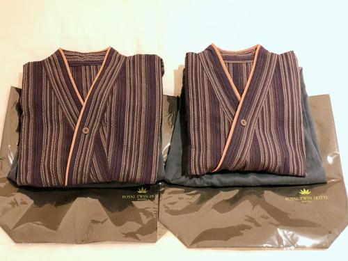 two brown bags sitting on top of a box at Royal Twin Hotel Kyoto Hachijoguchi in Kyoto