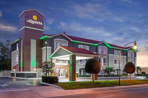a large building with a sign on top of it at La Quinta by Wyndham Tampa Bay Area-Tampa South in Tampa