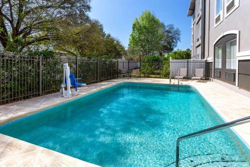 a swimming pool in the backyard of a house at La Quinta by Wyndham Tampa Bay Area-Tampa South in Tampa