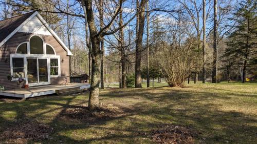 a small house with a porch in a yard at Private Berkshire Escape Special April Pricing select your dates for discount Monthly Pricing in Lee