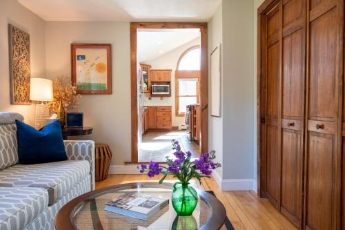 a living room with a vase of flowers on a table at Private Berkshire Escape Special April Pricing select your dates for discount Monthly Pricing in Lee