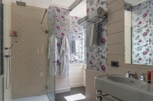 a bathroom with a shower and a sink at Q92 Noto in Noto