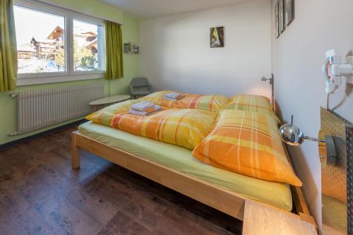 1 dormitorio con 1 cama en una habitación en apartment EGGERI - das sportliche en Grächen