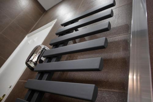a row of black seats on an escalator at Beautiful, Entire Luxurious One Bedroom Flat in Leicester