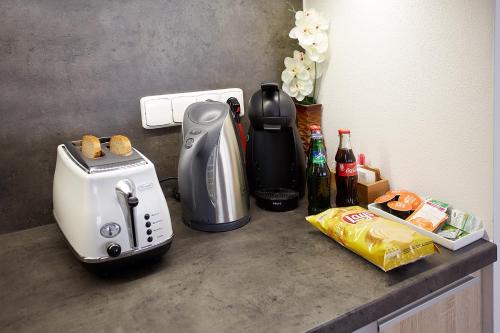 a kitchen counter with a coffee maker and a toaster at Apartmany Rezidence Klostermann & Javor & Skalka in Železná Ruda