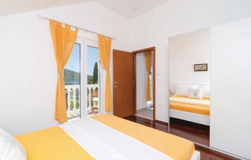 a bedroom with two beds and a window with a view at Bijela Villa in Slano
