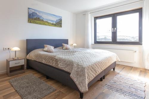 a bedroom with a bed and a large window at Haus Elena in Bestwig