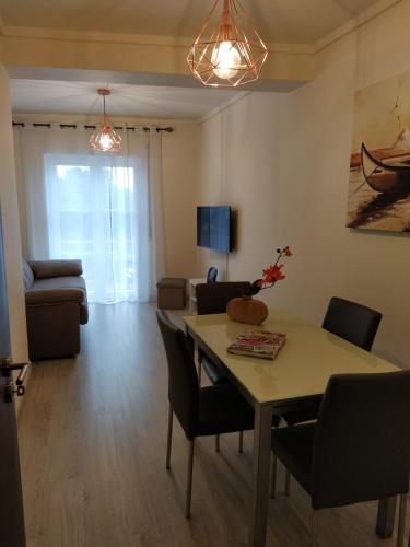 a living room with a table and chairs and a couch at Home Aveiro Ria in Aveiro