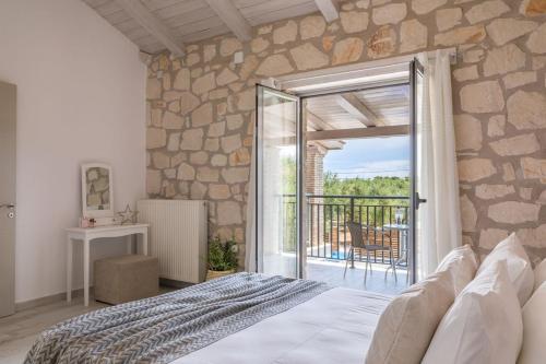 a bedroom with a bed and an open door to a balcony at Ionio villa Zafeiris in Vasilikos