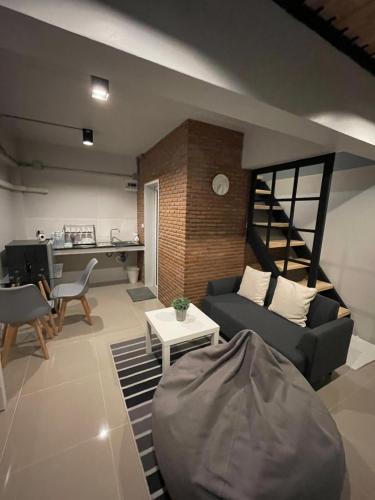 a living room with a couch and a table at Sealoft,Pattaya in Bang Lamung