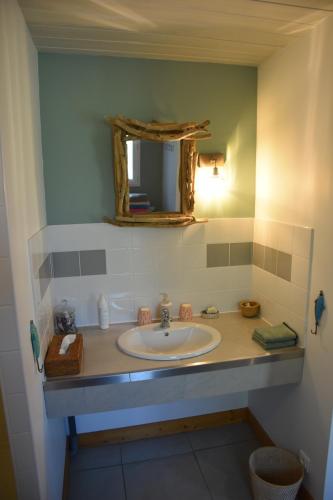 a bathroom with a sink and a mirror at Sherwood in Étretat