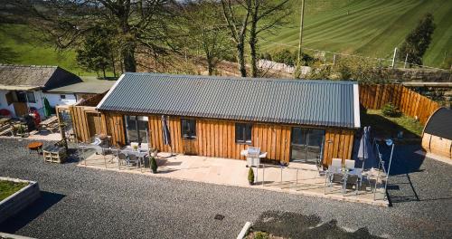 an overhead view of a wooden building with tables and chairs at Newlands Farm Stables in Kendal