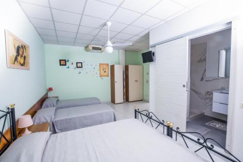a hospital room with two beds and a tv at Residence Daniele in Bellaria-Igea Marina