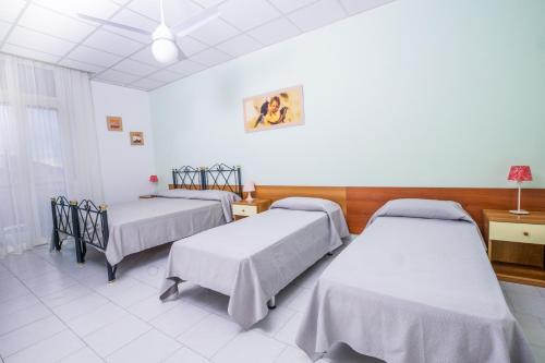 a hospital room with two beds and a window at Residence Daniele in Bellaria-Igea Marina