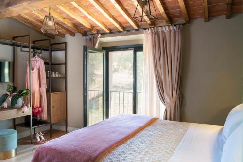 a bedroom with a bed and a window at Borgo I Vicelli Adults Only Relais in Bagno a Ripoli