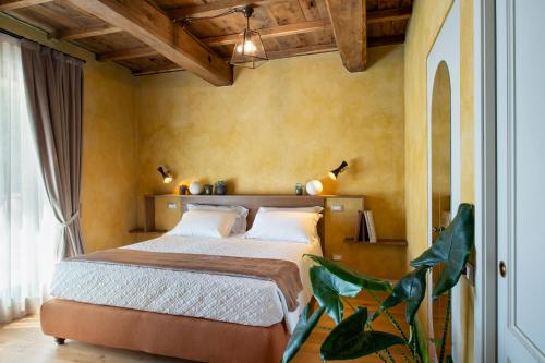 a bedroom with a bed in a room at Borgo I Vicelli Adults Only Relais in Bagno a Ripoli