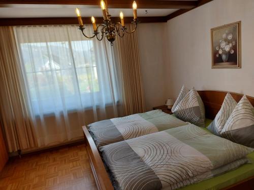 a bedroom with a bed in front of a window at Ferienhaus und Ferienappartements Brunner in Höchst