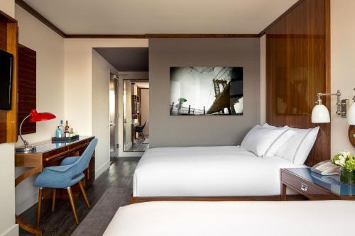 Säng eller sängar i ett rum på Hotel Hugo