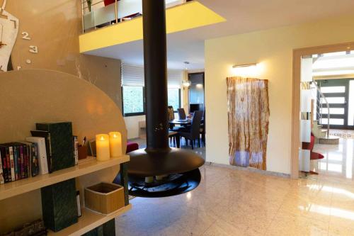 a living room with a stove in the middle of a room at La Cantera Rural Spa in Viñaixa